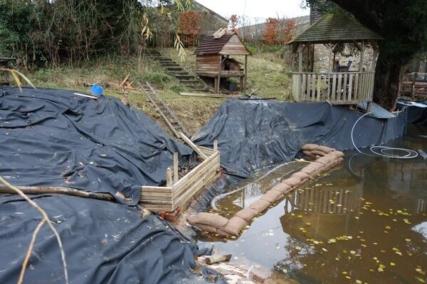 Laying the pond liner and the early stage of filing the pond