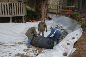 Garden pond liners being installed into a complex shaped pond