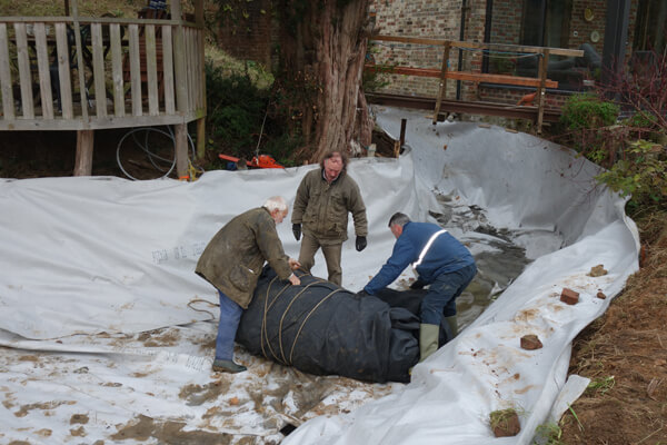 Laying the pond liner and the early stage of filing the pond