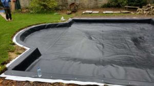 Formal garden pond with box-welded pond liner installed to give a neat crease-free finish