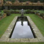 Box welded pond liner contains the water in this rectangular garden pond